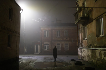 Woman in a foggy old city