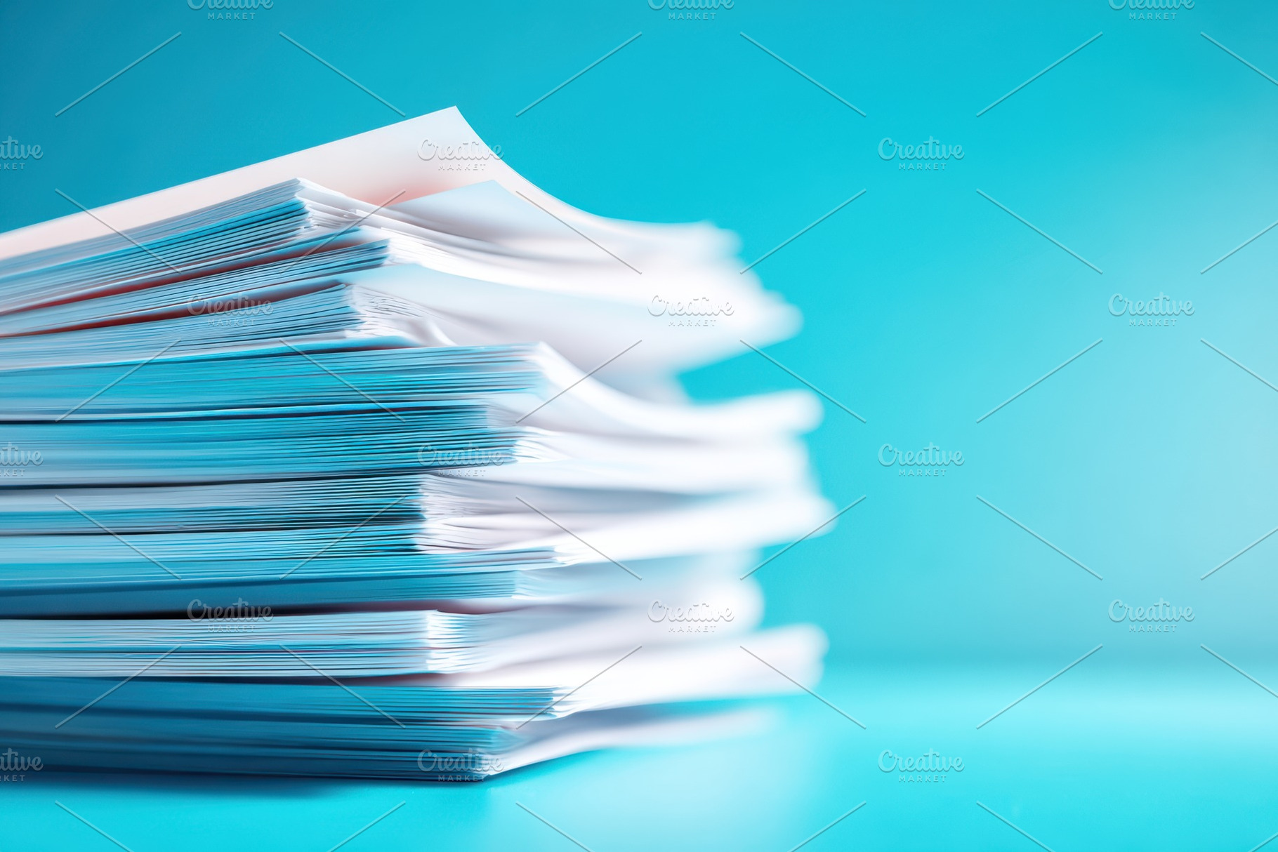 Stack of white documents on blue background, a Business Photo by AlyaAnd