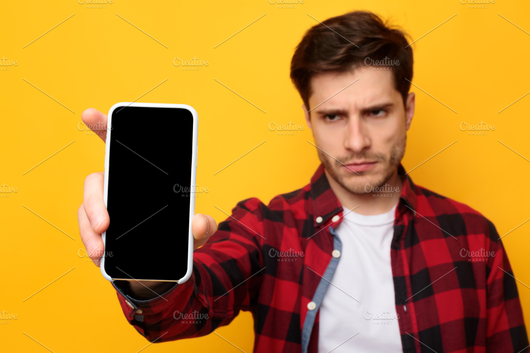 Sad guy holding showing empty smartphone screen, a Photo by Prostock-Studio