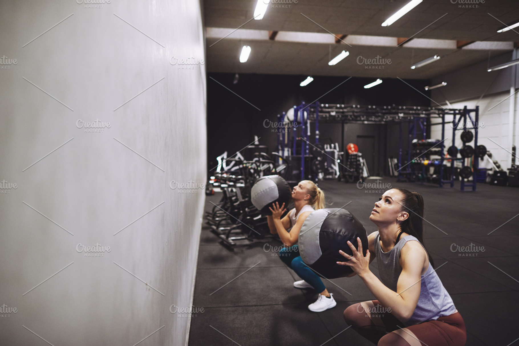 Two women working out with medicine balls at the gym, a Sports & Recreation Photo by Stefan & Janni