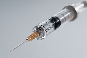 Close-up of a sterile syringe with a clear body and fine needle, symbolizing me, a Business Photo by ImageMir
