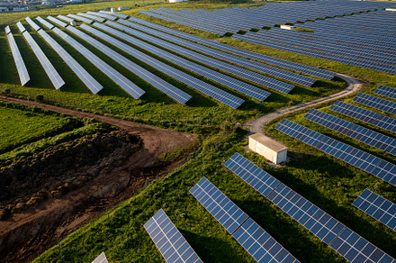 Vast solar panel field showcasing renewable energy generation in a rural landsc
