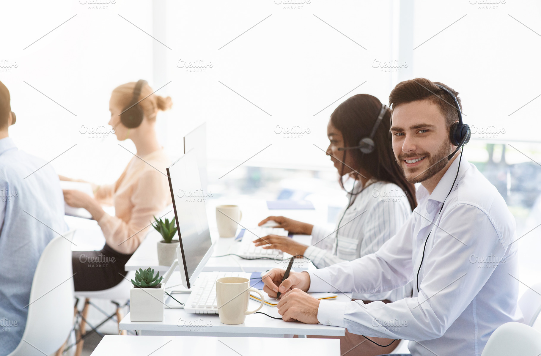 Attractive call center operator smil, a Photo by Prostock-Studio