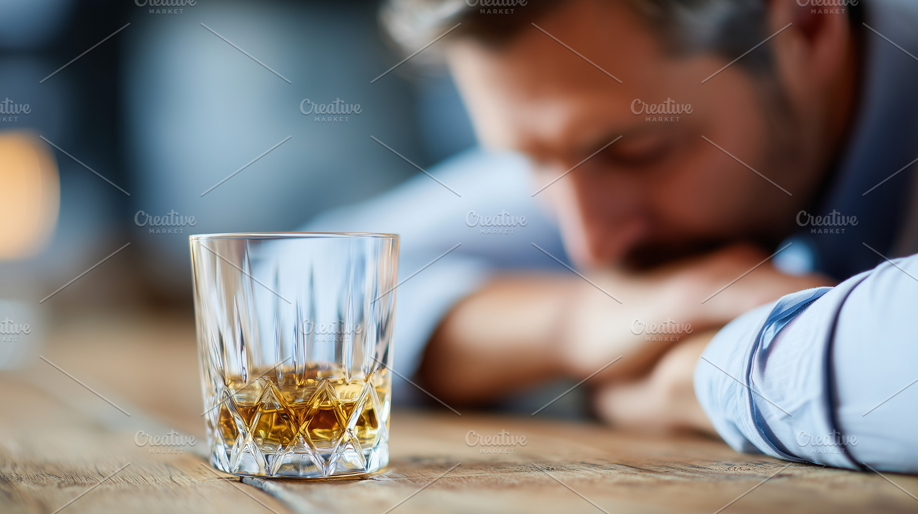 Sad man sits with his head down next, a Person Photo by MistyDay