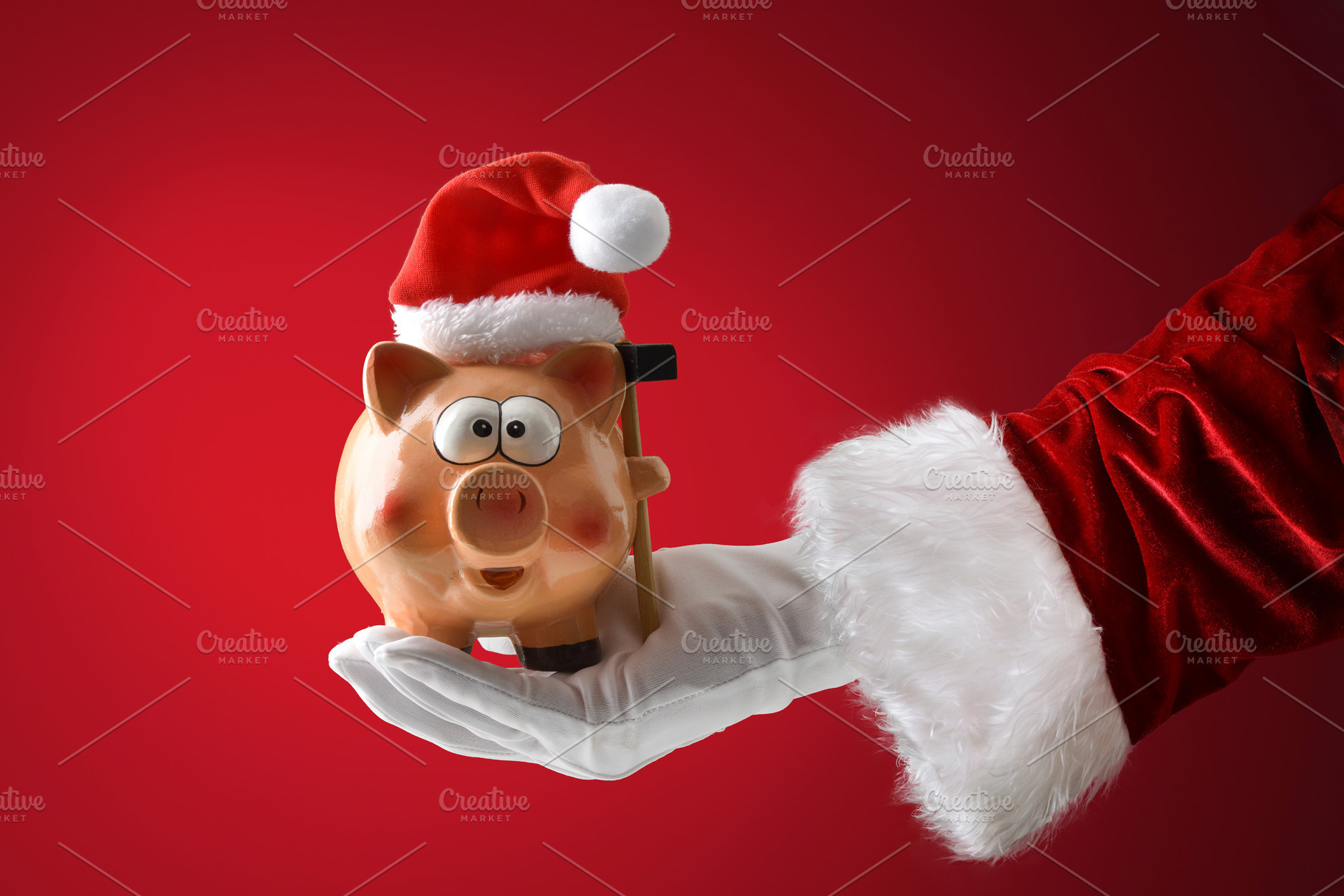 Santa Claus holding a piggy bank on red isolated background, a Person Photo by Davizro's Market