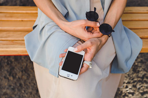 Girl holding iphone mock up containing mock up, iphone 4, and phone