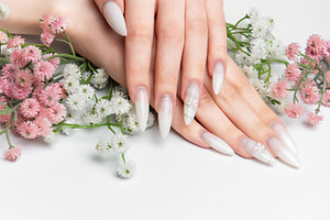 Woman showing hands with long white ombre nails, a Health & Medical Photo by Olena Rudo