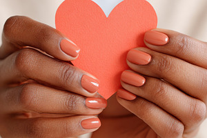 Hands holding a red heart cutout, a Holiday Photo by AlyaAnd