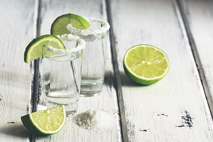 Tequila shot with juicy lime slice stock photo containing tequila and alcohol