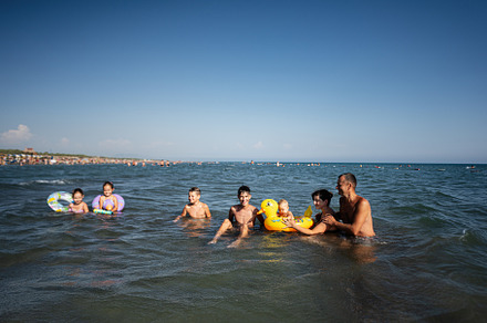 Large family enjoying a sunny day at the beach, playing in the water in Ulcinj,, a Photo by AS photostudio