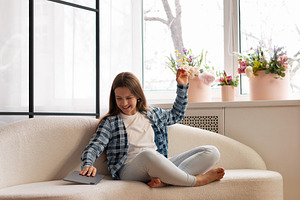 Smiling teen girl playfully placing, a Person Photo by Elena Vagengeim