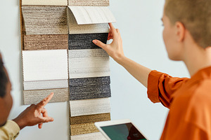 Design meeting examining material samples, a Photo by DanFLCreativo
