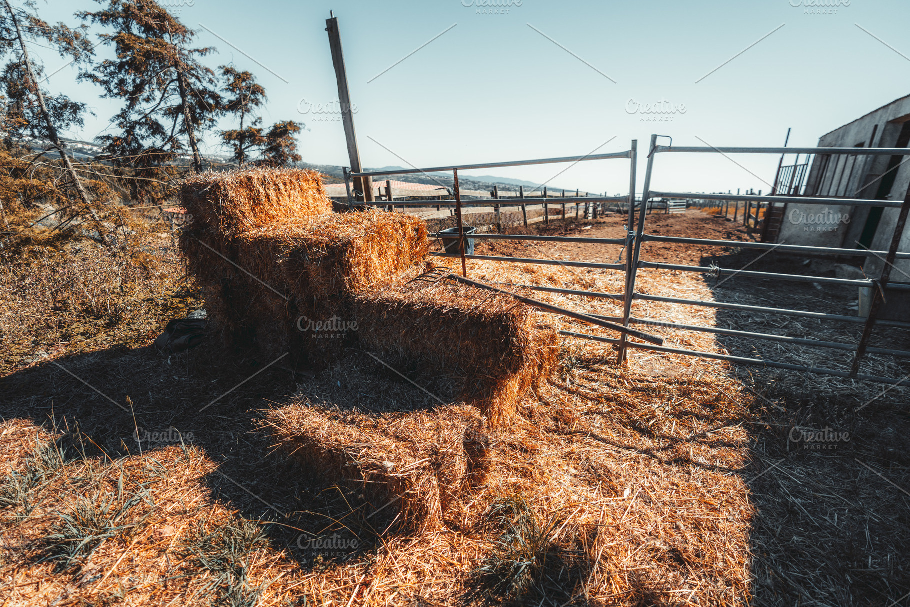 Hay Bales Beside Empty Farm Pen, an Industrial Photo by SkyNext