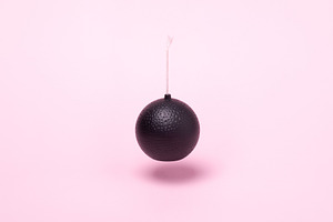 Minimalist image of a black spherical bomb with a fuse, centered, a Technology Photo by Ales Munt