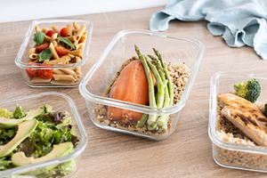 Healthy meal prep containers with salmon, chicken, pasta and fresh vegetables, a Food & Drink Photo by etorres69