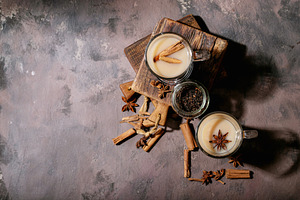 Masala chai served with cinnamon containing chai, drink, and coriander