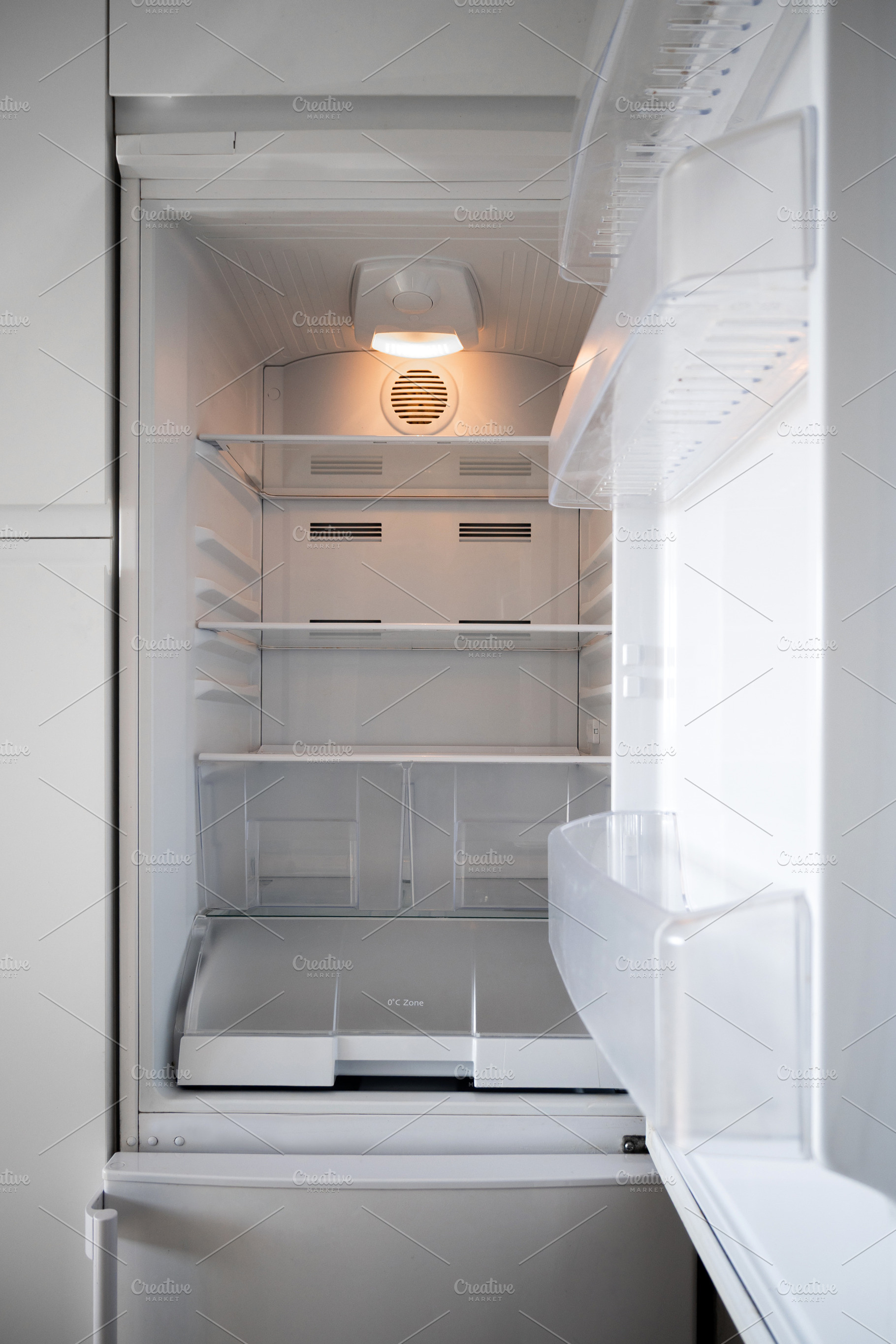 Empty open refrigerator with clean shelves in modern kitchen, a Food & Drink Photo by etorres69