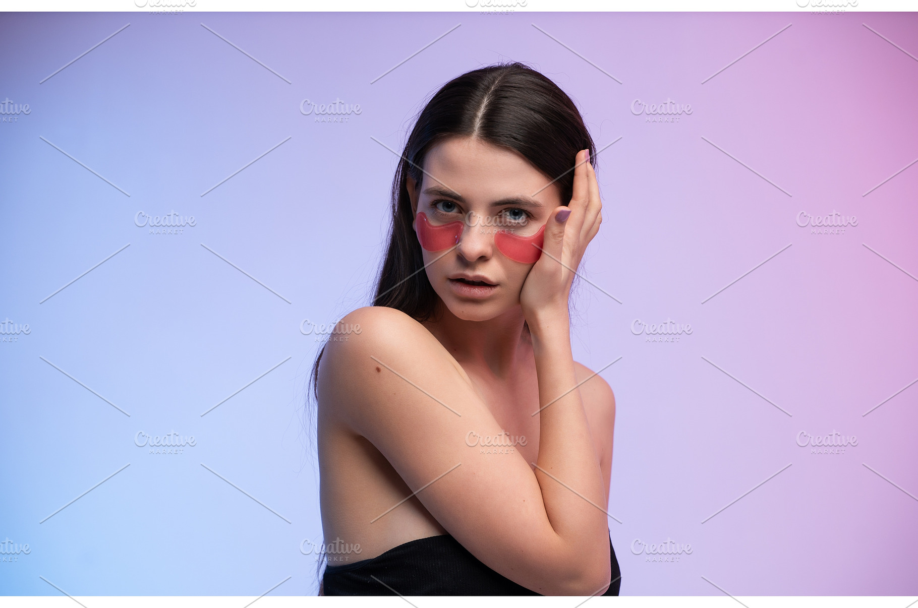 Woman applying pink eye patches for, a Health & Medical Photo by volodymyrshtun13795