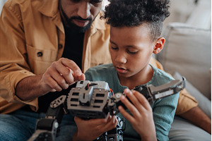 Father and son exploring STEM, a Technology Photo by HalfPoint