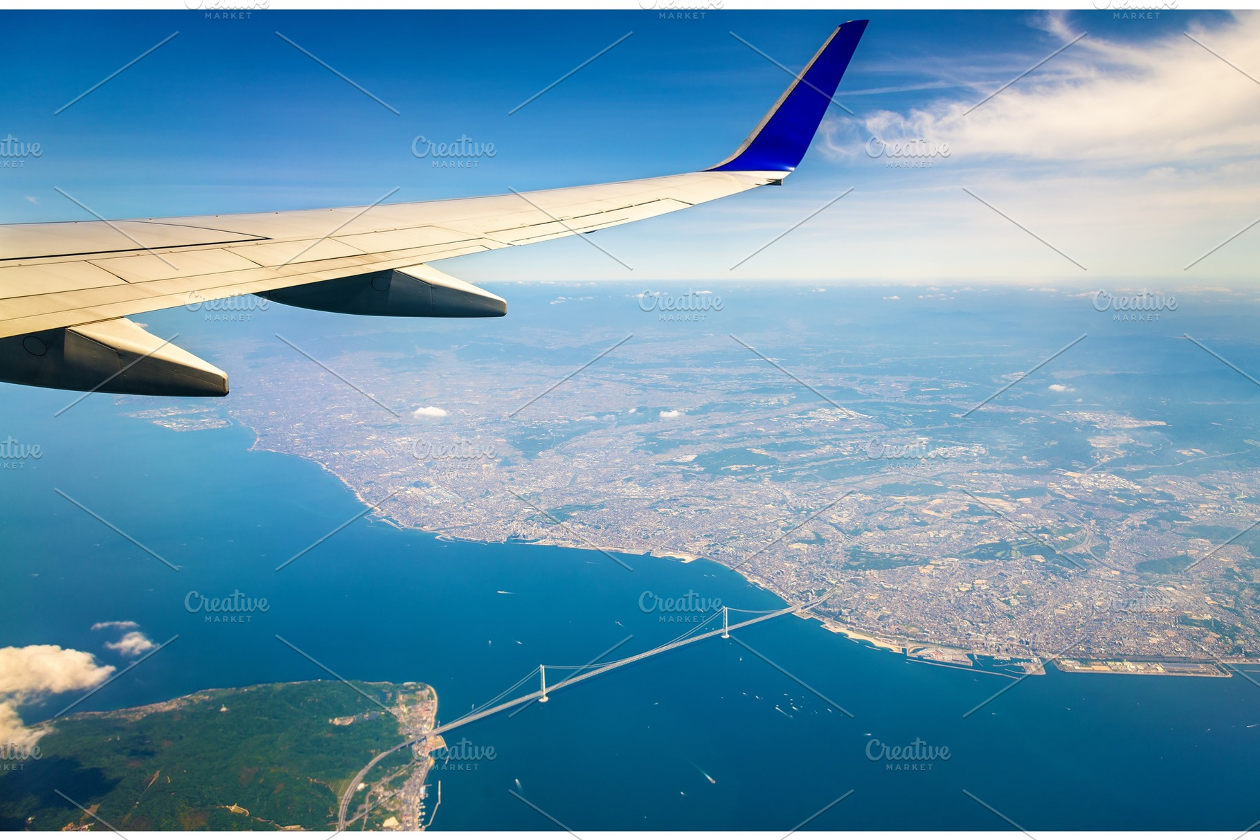 Flying above Japan, the Akashi Kaikyo Bridge seen through an airplane window, a Transportation Photo by Leonid Andronov
