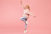Playful caucasian woman jumping and having fun over pink studio background, lad, a Photo by Prostock-Studio (Thumbnail 2 of 3)