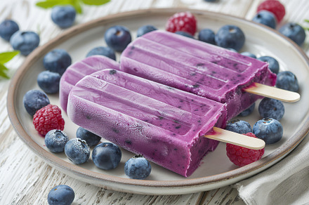 Ice cream popsicles with organic blueberries on wooden background, a Food & Drink Photo by AlyaAnd