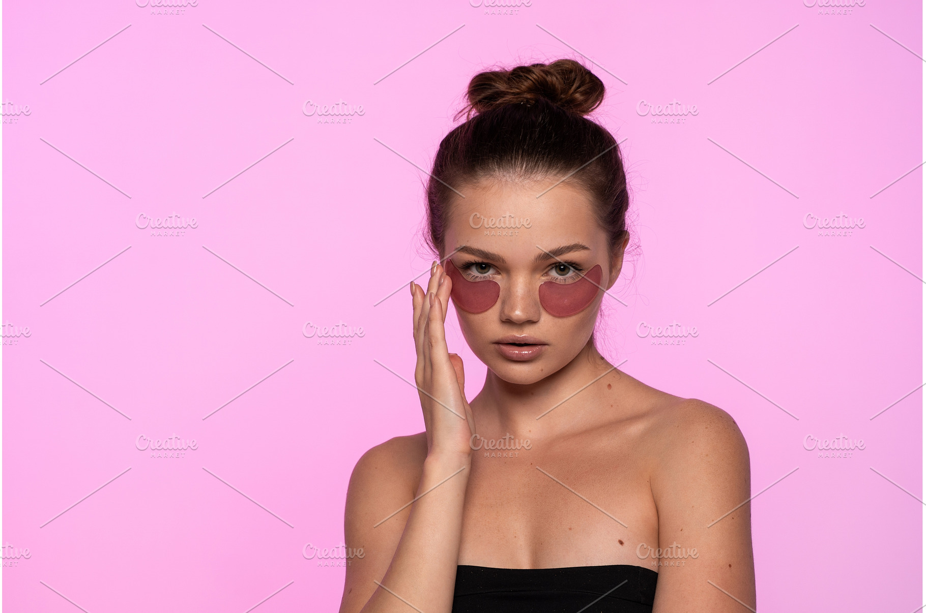 Young woman applying pink hydrating, a Beauty & Fashion Photo by volodymyrshtun13795