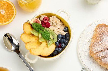 plate with oatmeal and fruit, half a ripe orange and freshly squ, a Food & Drink Photo by ndanko