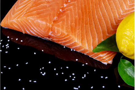 Salmon on black wooden table top, a Food & Drink Photo by Ungvar Studio
