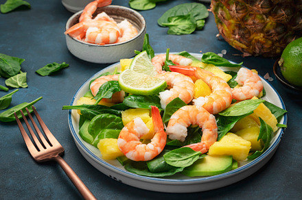 Pineapple salad with shrimps, spinach, avocado and lime on blue, a Food & Drink Photo by 5PH