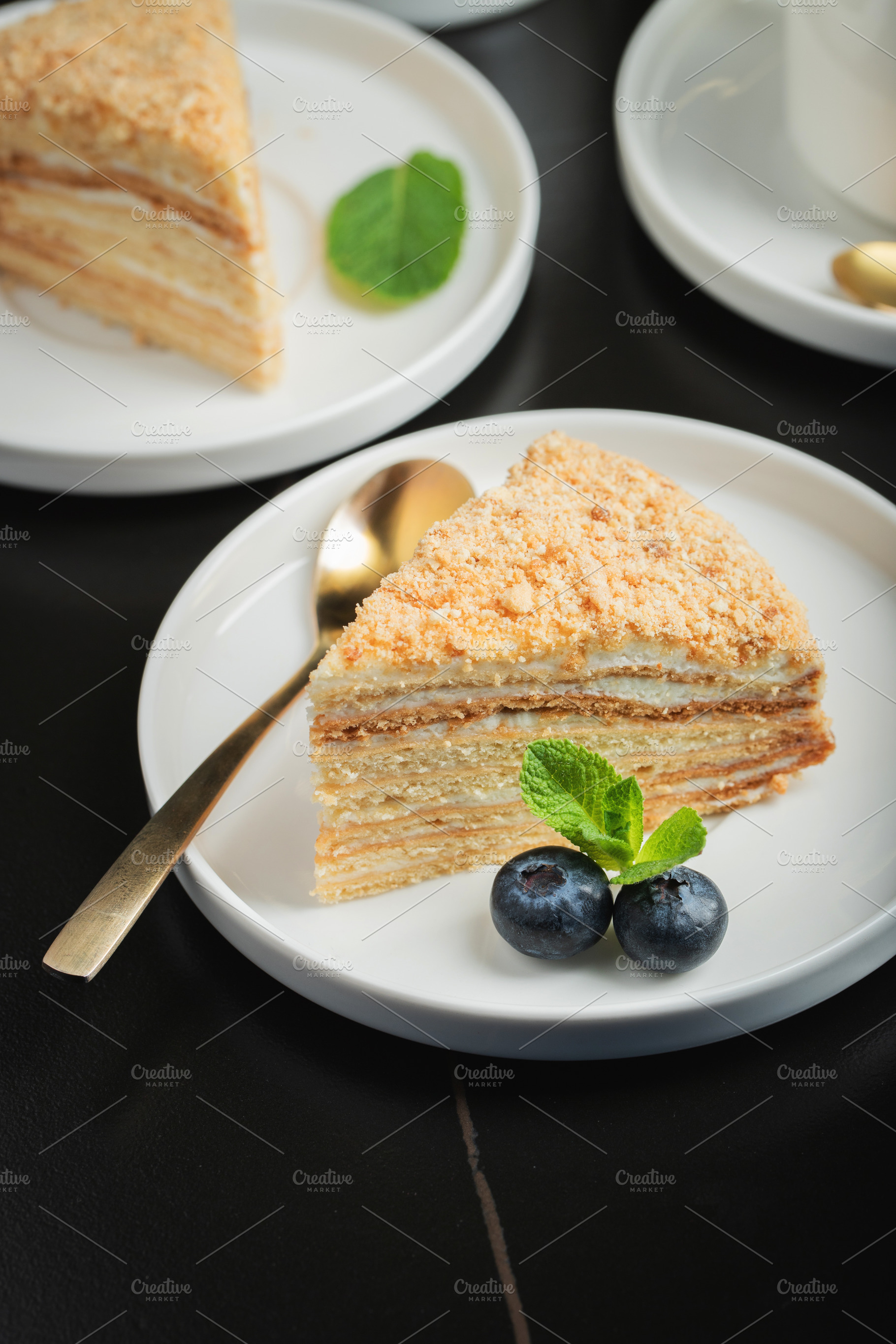 Medovik. Honey cake made from honey cakes with whipped sour cream, decorated wi, a Food & Drink Photo by Budarinphoto