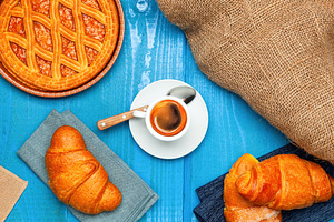 Italian breakfast with espresso coffee, croissants and tart on blue wooden tabl, a Food & Drink Photo by Antonio Gravante Market