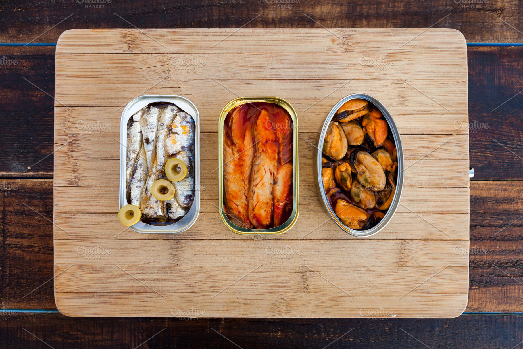Three different opened cans of preserved, a Food & Drink Photo by José Manuel Gelpi