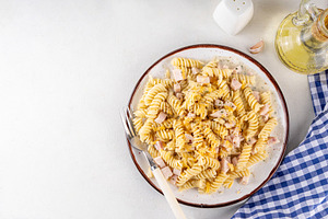 Tasty creamy fussilli carbonara pasta with ham, a Food & Drink Photo by Rimma