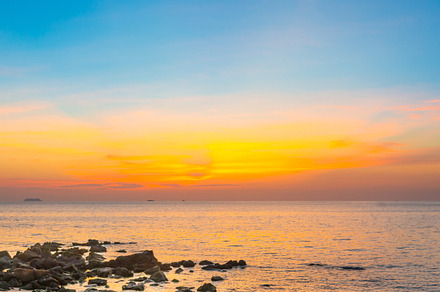 Sunset beach with sea and rocks, a Nature Photo by Vapi