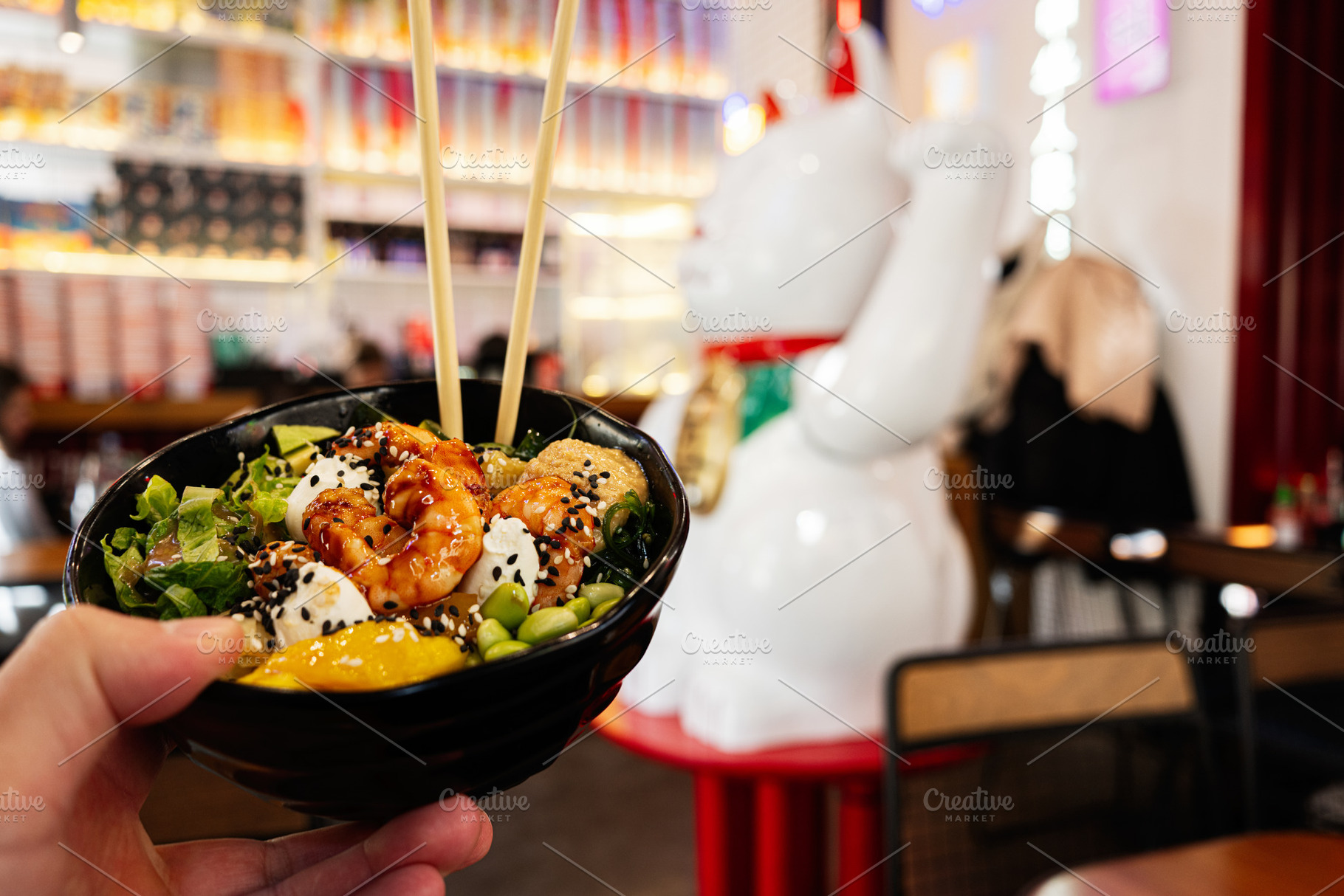 Close-up of a colorful poke bowl with shrimp in a vibrant restaurant setting, a Photo by AS photostudio