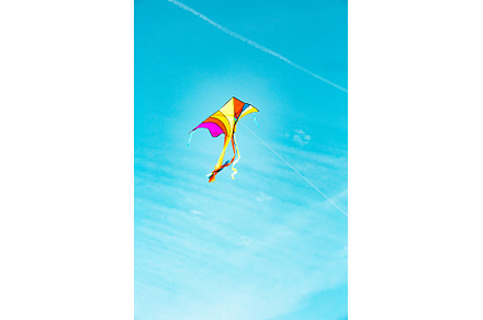 Colorful kite flying freely in the, a Background Photo by Rodica Ciorba