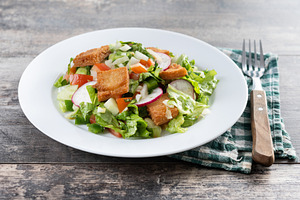 Fattoush salad, Traditional Lebanese Salad on wooden table, a Food & Drink Photo by etorres69