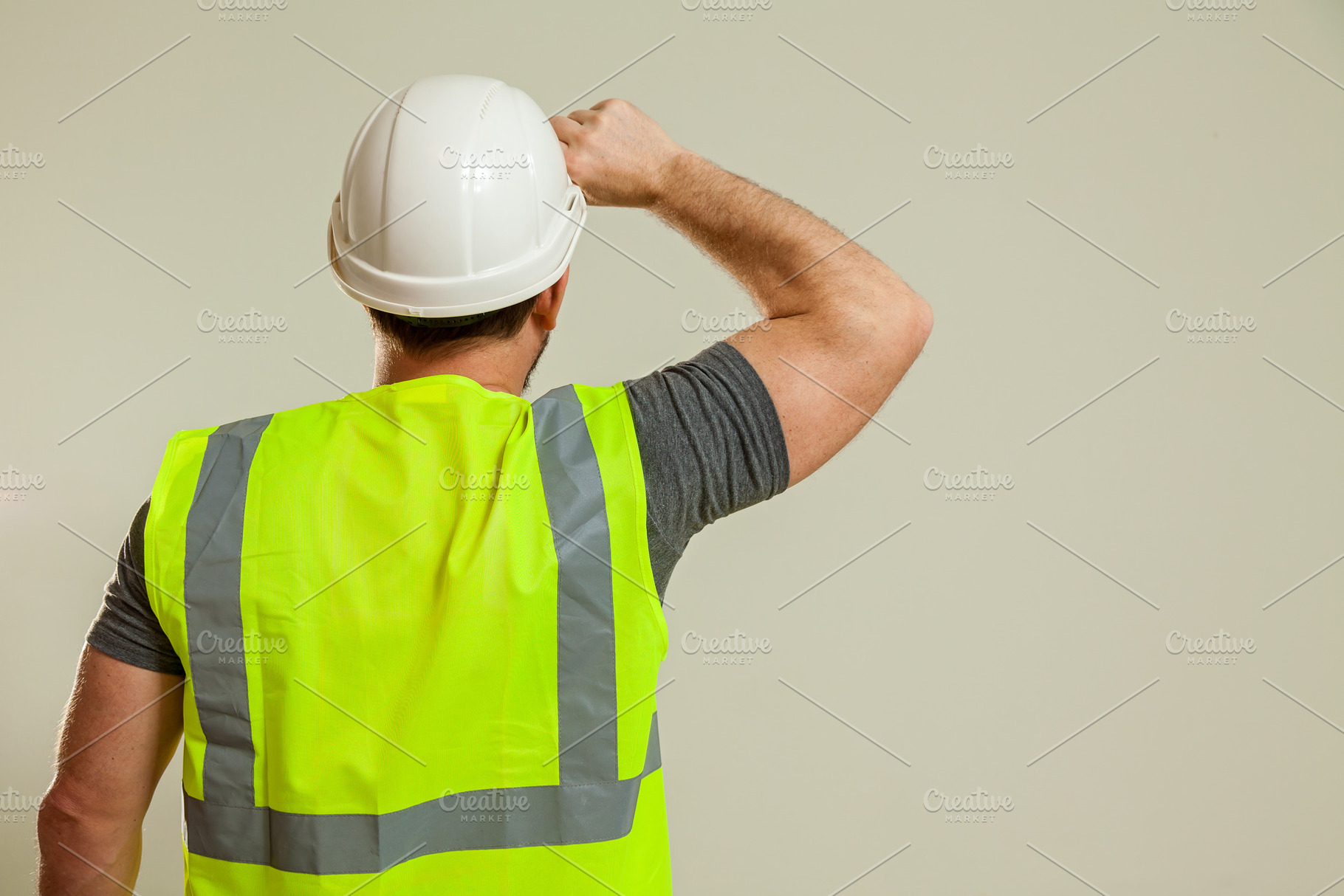 worker in a vest and white helmet, a Person Photo by Photostock