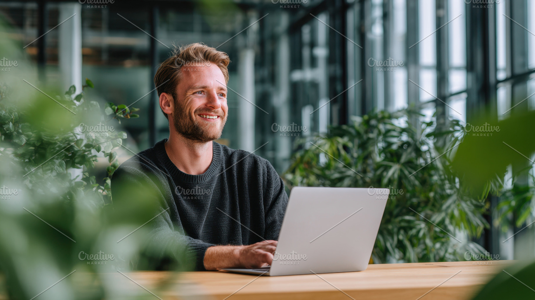 Man works on laptop in bright space, a Photo by Beautiful things