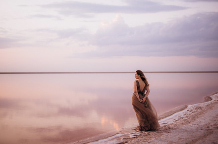 girl on the shore of a pink salt lake, a Person Photo by Weddings, People, Travel