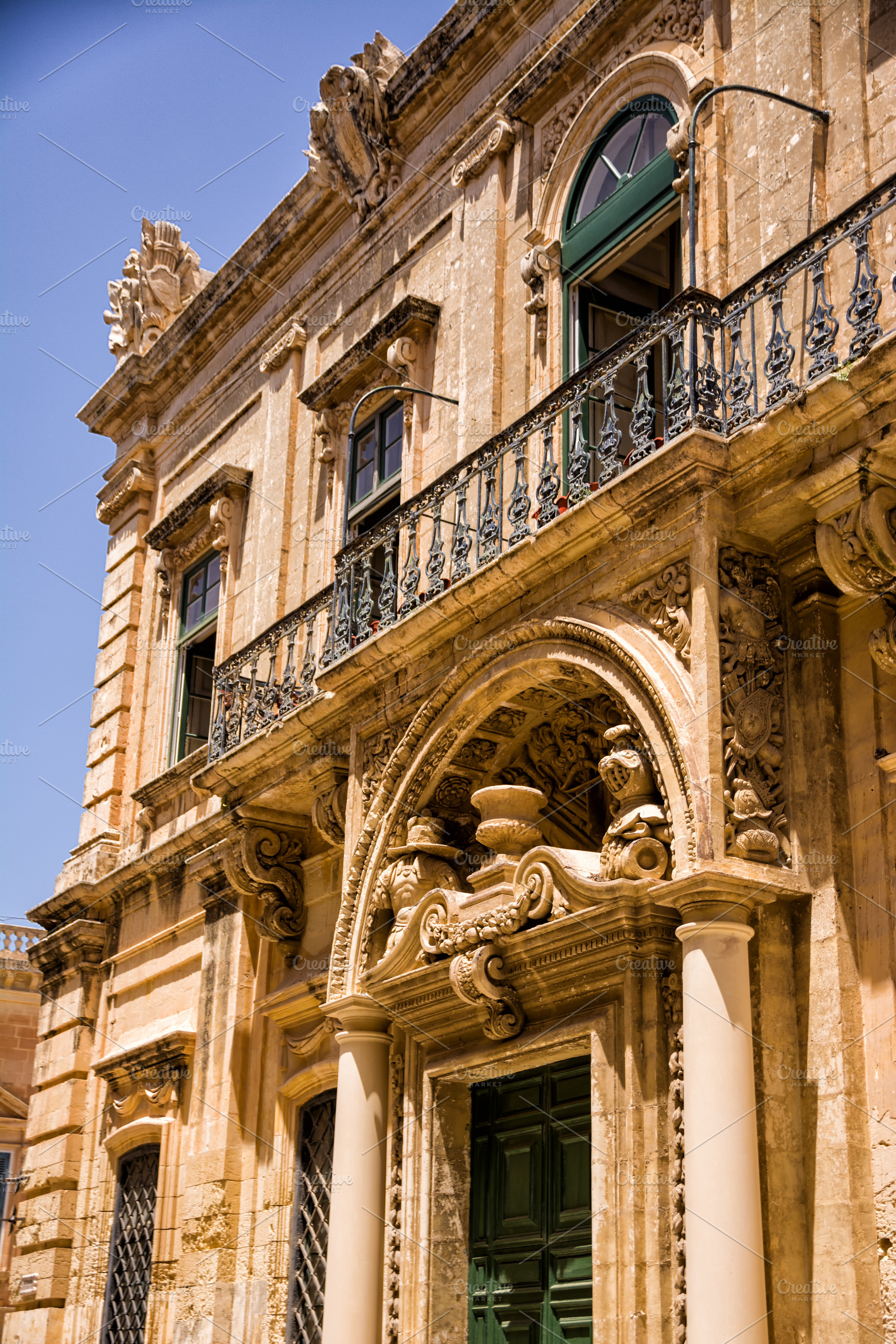 Facade of a building, door and balconies with worked structure i, an Architecture Photo by Angelo D'Amico Photograph