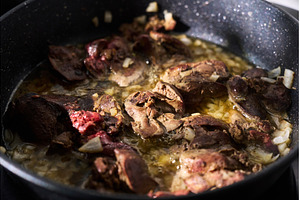Cooking liver pieces in a frying pan, a Background Photo by darksoul72