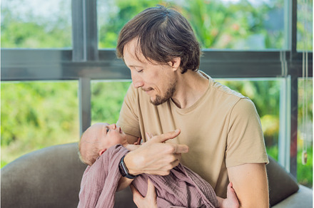 Dad and newborn at home. This tender