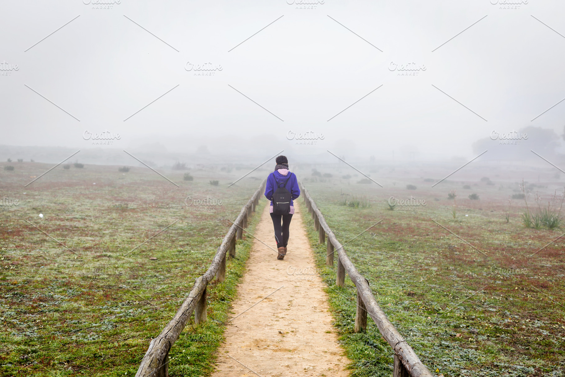 Traveler woman on a field by fog, a Person Photo by Shootdiem