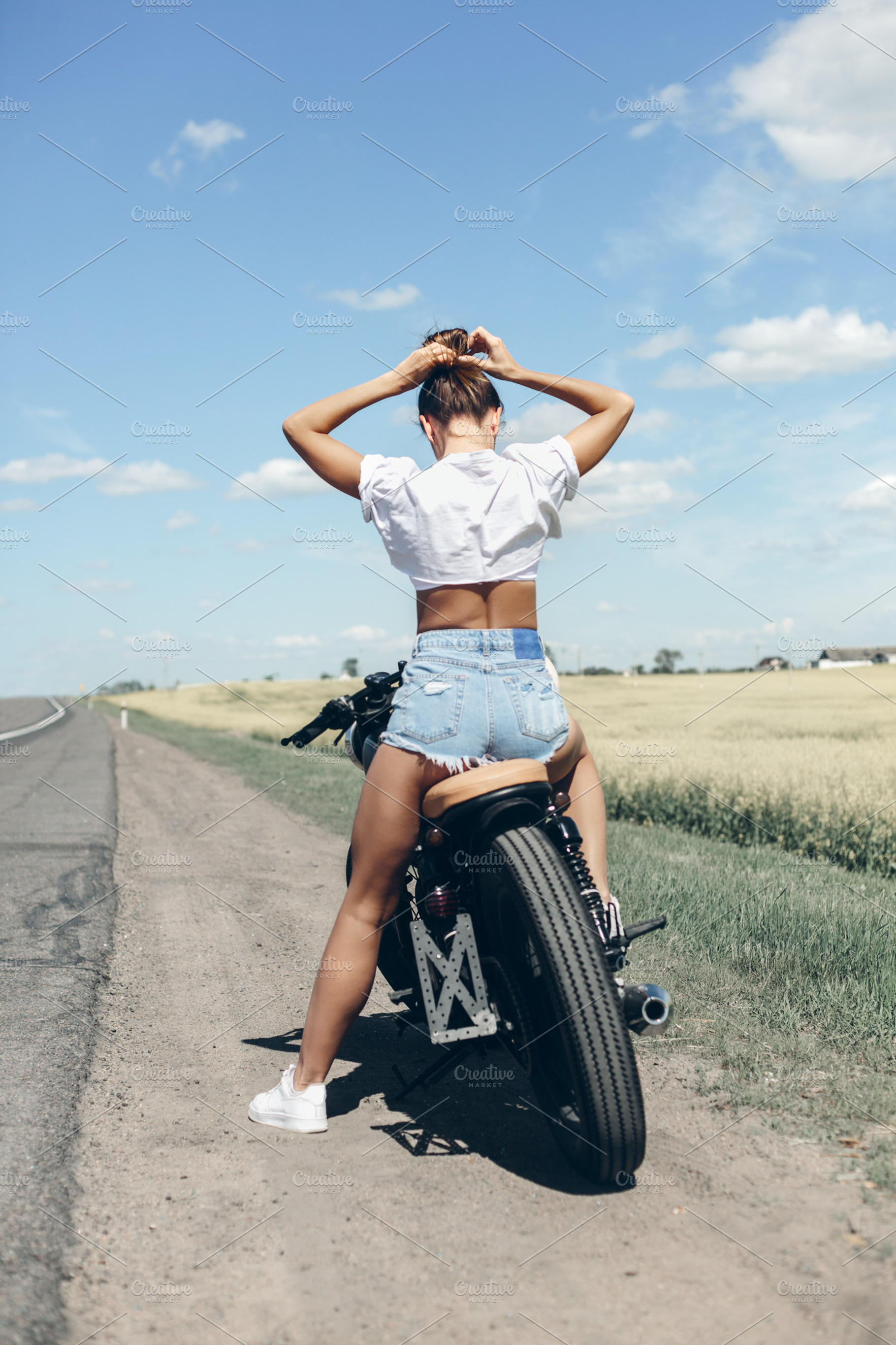 Biker girl sitting on motorcycle containing woman, fashion, and retro, a Transportation Photo by Aliaksei Kaponia
