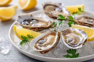 Fresh oysters on ice with lemon and parsley, a Food & Drink Photo by AlyaAnd