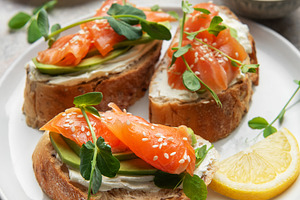 Salmon avocado toasts with microgreens and lemon, a Food & Drink Photo by Olena Rudo