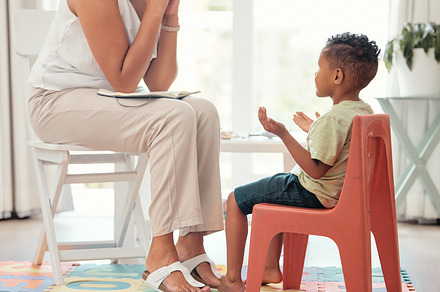 Autism, education and mental health by therapist and child learning different hand sign to express feelings in living room. Teaching, speech and child development with boy and woman lesson on emotion, a Photo by Peopleimages.com