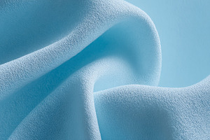 Blue fabric creating soft flowing waves and abstract textures, s, a Photo by Studio ANNA